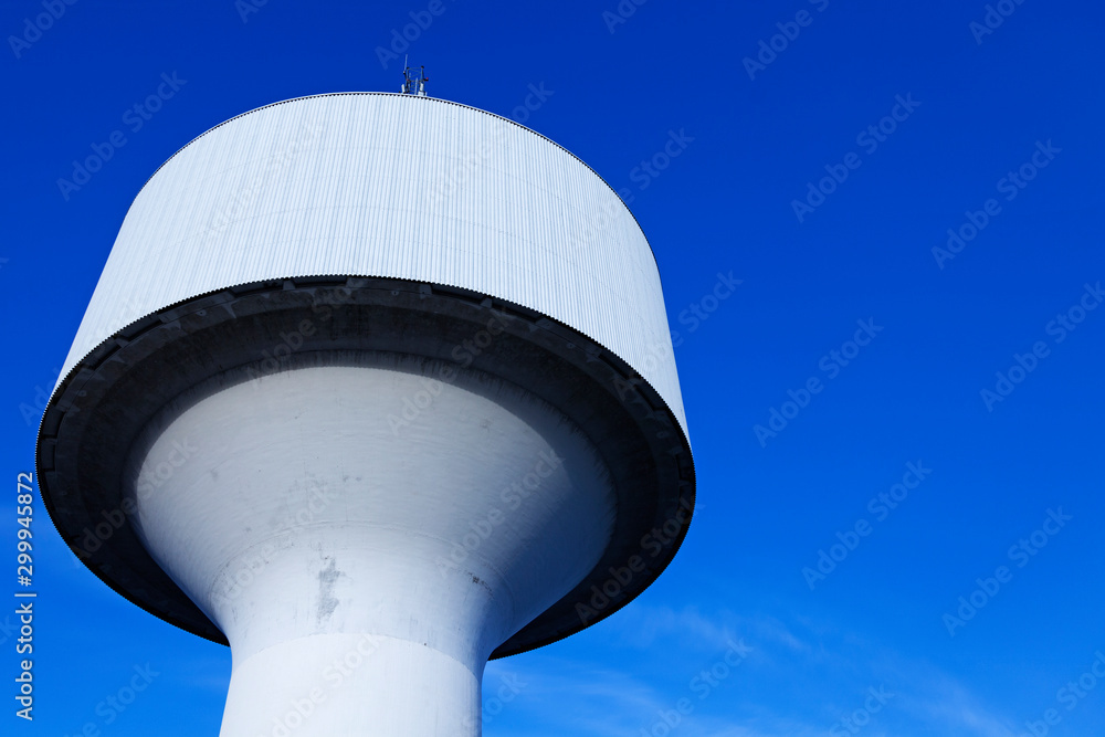 Umea, Norrland Sweden - October 10, 2019: water tower seen a bit away with blue sky Umea, Norrland Sweden - October 10, 2019: water tower seen a bit away with blue sky