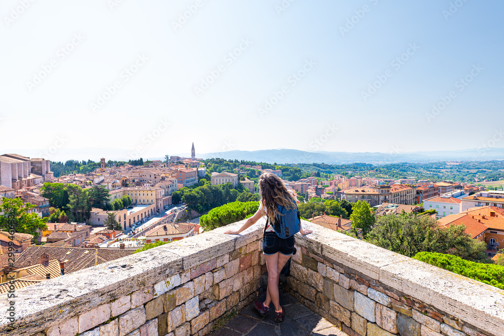 Panoramic view in Perugia Umbria, Italy cityscape of Church of San Domenico tower and rooftops of town village in summer landscape with woman at overlook Panoramic view in Perugia Umbria, Italy cityscape of Church of San Domenico tower and rooftops of town village in summer landscape with woman at overlook