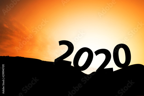 Silhouette of year 2020 with sunrise on mountain. Starting of new year concept.