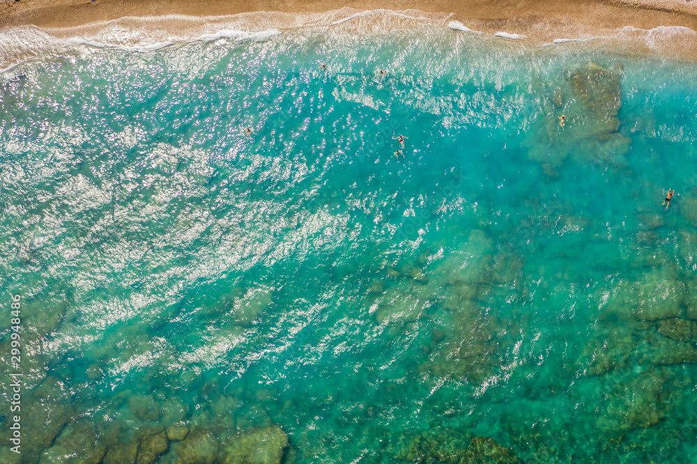texture of sea with clear turquoise water and bottom top view with the drone. iridescent yellow blue colors
