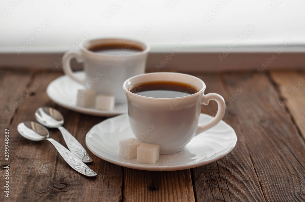 Coffee on a wooden table in white mugs Coffee on a wooden table in white mugs