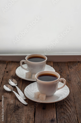 Coffee on a wooden table in white mugs