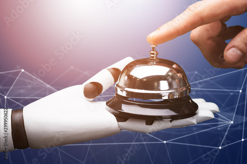 Person Ringing Service Bell Hold By Robot photo