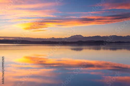 Monte Rosa reflecting on Lake Varese during a winter sunset at Calcinate del Pesce, Varese Province, Lombardy, Italy.