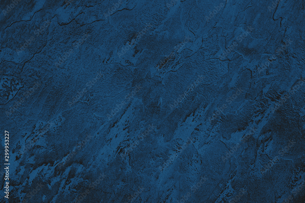 Dark blue colored low contrast stone textured background with roughness and irregularities to your design or product. Color trend concept. Dark blue colored low contrast stone textured background with roughness and irregularities to your design or product. Color trend concept.