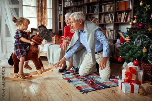  grandparents and little girl playing together for Christmas