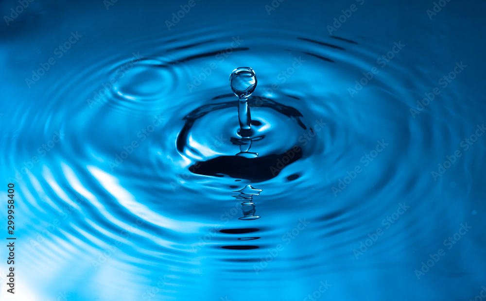 water drop and water splash, blue water surface water drop and water splash, blue water surface