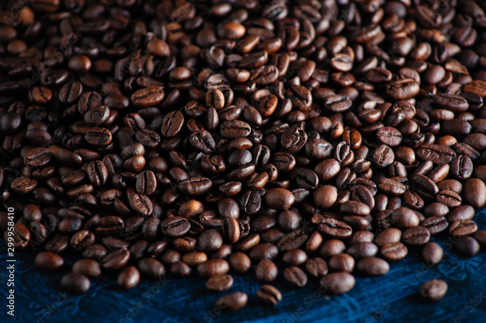 roasted aromatic coffee beans closeup sprinkled on a table roasted aromatic coffee beans closeup sprinkled on a table