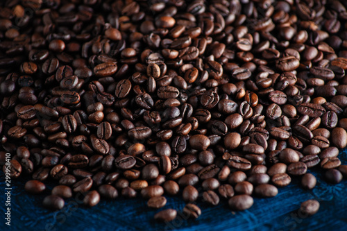 roasted aromatic coffee beans closeup sprinkled on a table