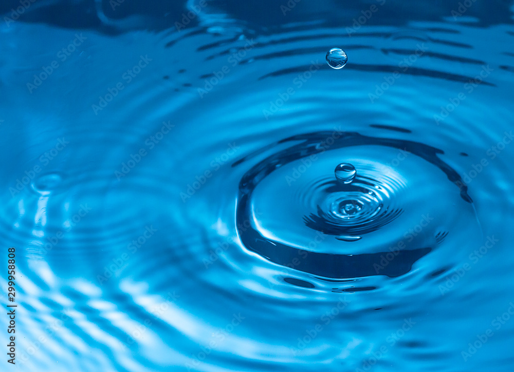 water drop and water splash, blue water surface water drop and water splash, blue water surface
