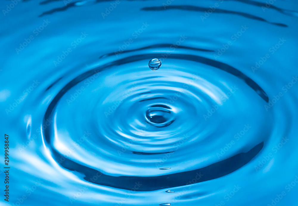 water drop and water splash, blue water surface water drop and water splash, blue water surface
