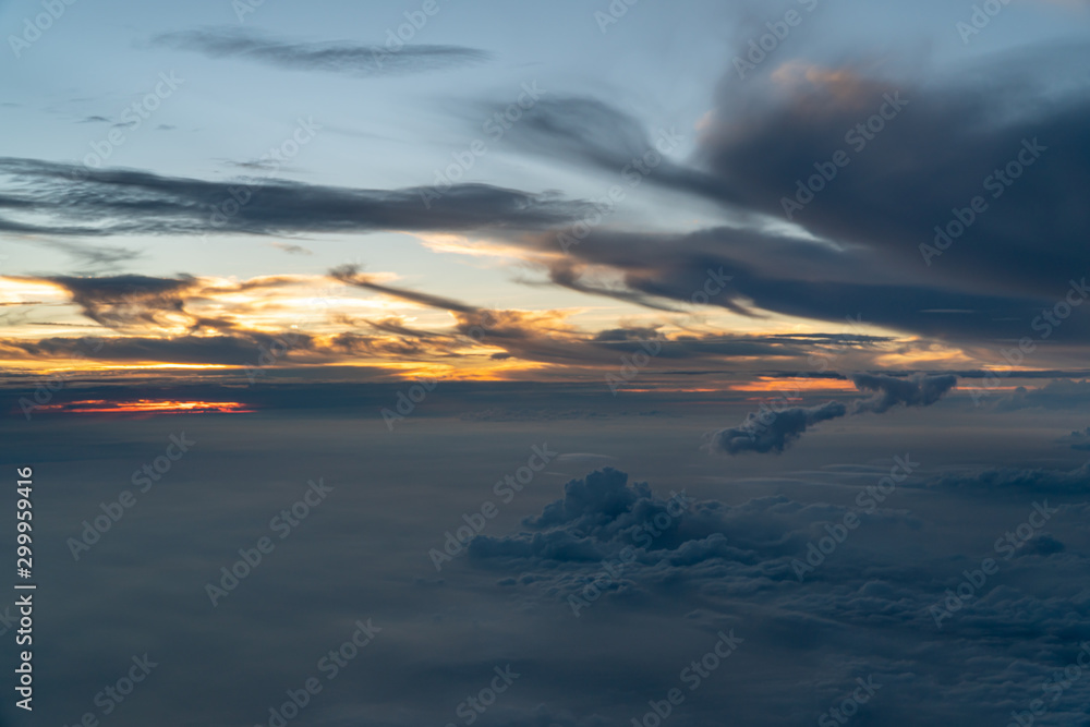 Fototapeta premium Blue hour above the clouds - View from an airplane during blue hour