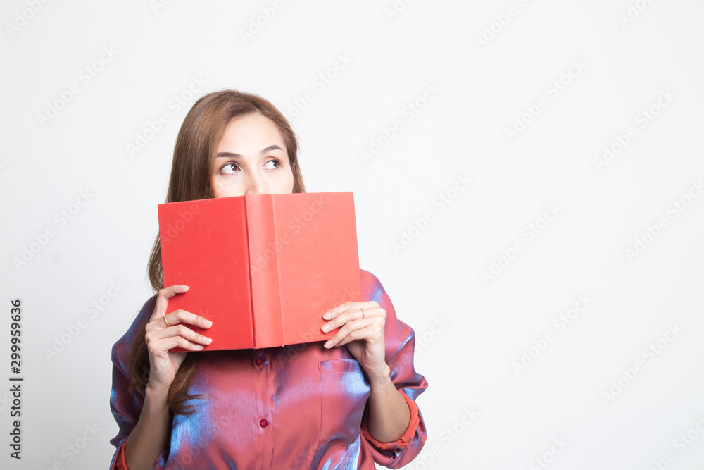 Young Asian woman with a book cover her face. Young Asian woman with a book cover her face.