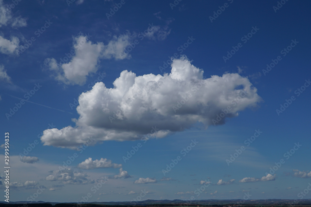 A big, white cloud on the blue sky