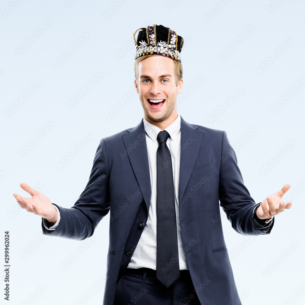 I am business king! Portrait of happy smiling young businessman in fake crown, isolated over grey color background. Leadership and business success concept picture I am business king! Portrait of happy smiling young businessman in fake crown, isolated over grey color background. Leadership and business success concept picture