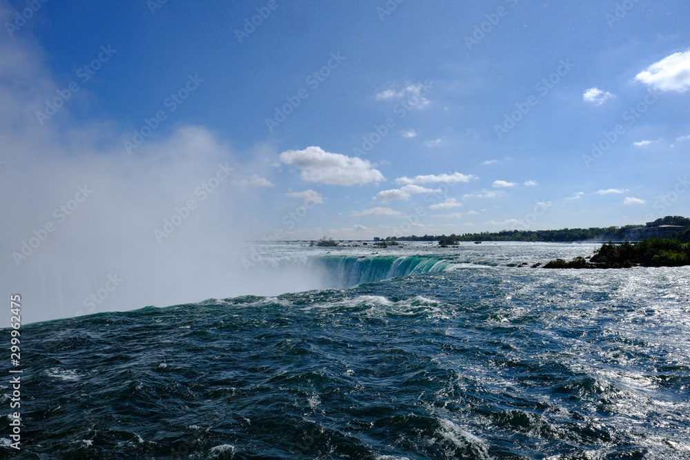 Magnificent Niagara Falls as seen near the main waterfall ledge showing the large rampant of mist produced.