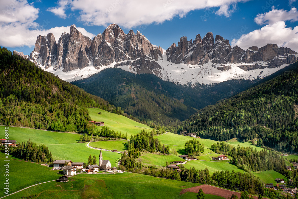 The Valley Val di Funes in Italy . Santa Maddalena church, on background the Odle group mountains.