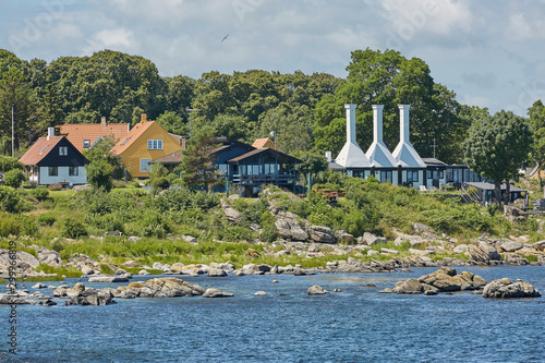 The roofs and chimneys of very small smoke houses so typical and famous for small village of Svaneke on Bornholm island in Denmark