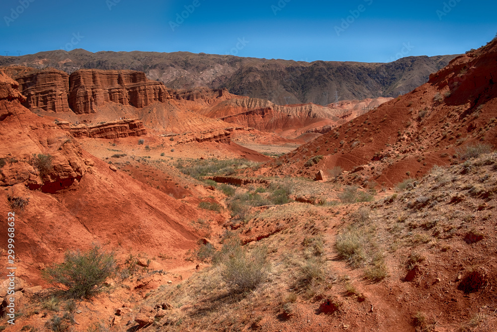 fantastic clay red castles in the sandy desert of the canyon Konorchek, in Kyrgyzstan fantastic clay red castles in the sandy desert of the canyon Konorchek, in Kyrgyzstan