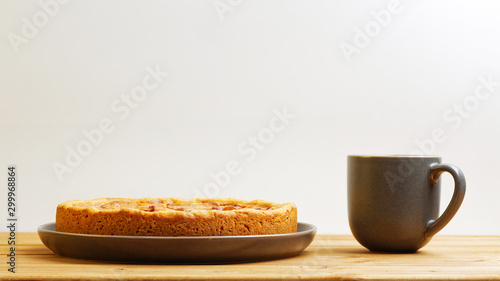 Homemade apple pie and cup of tea on wooden table. Front view with copy space.
