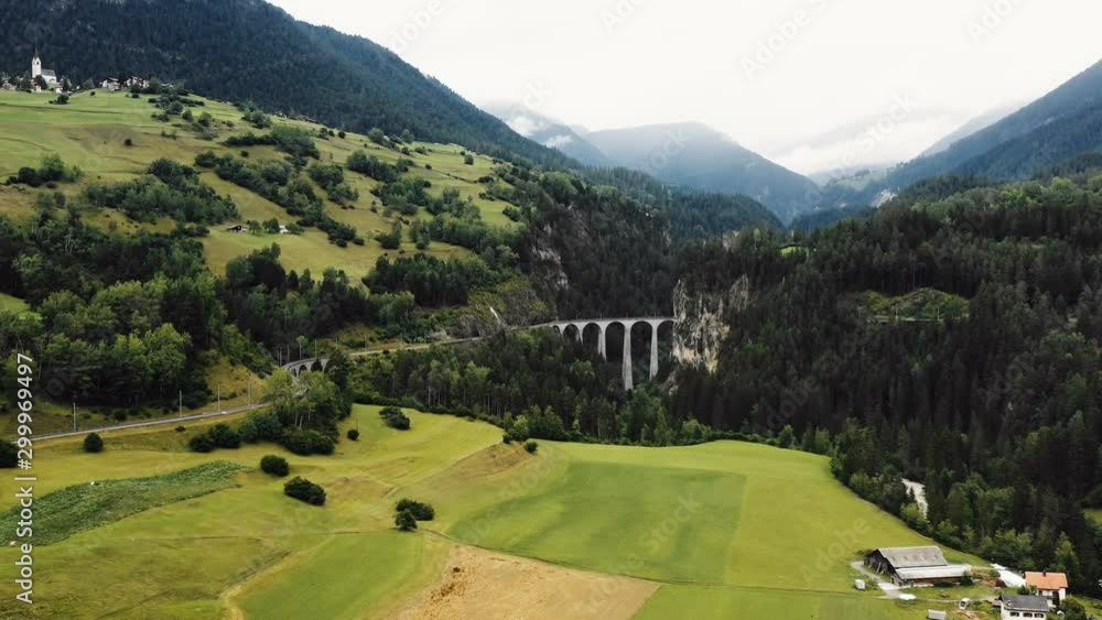 Drone flying towards Landwasser Viaduct bridge, world famous heritage sight in amazing summer Graubunden, Switzerland. Drone flying towards Landwasser Viaduct bridge, world famous heritage sight in amazing summer Graubunden, Switzerland.