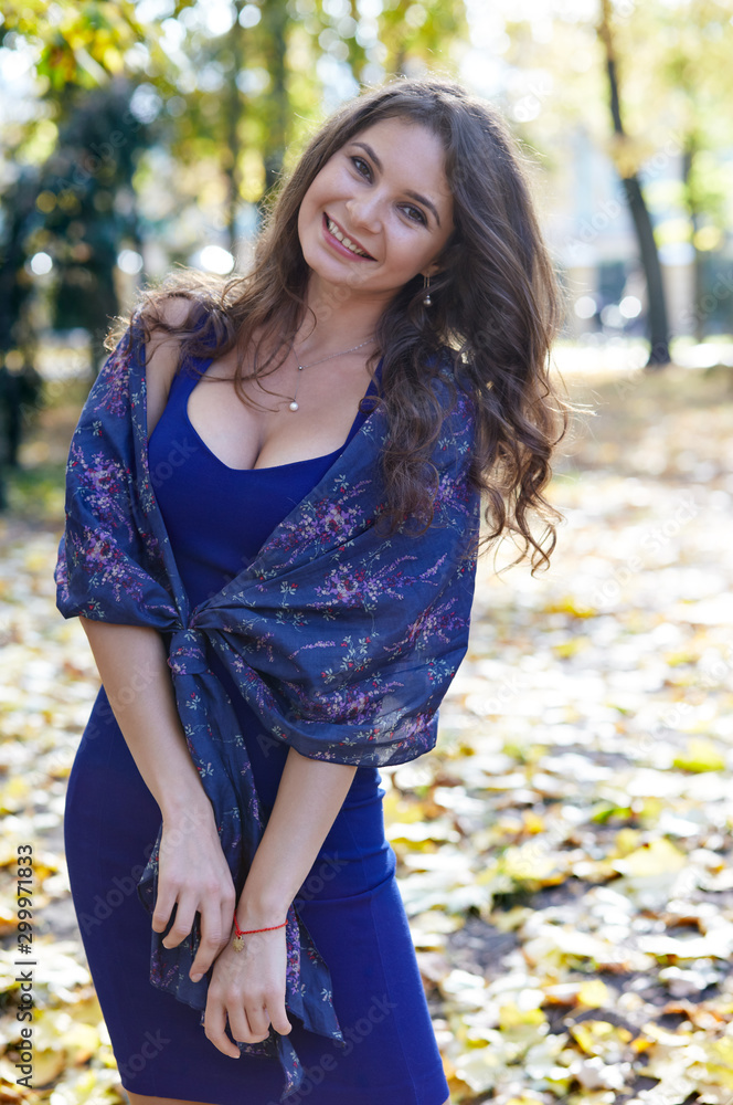 Beautiful attractive girl walks in the park. The bright colors of fall Beautiful attractive girl walks in the park. The bright colors of fall