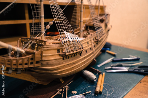 the manufacturing process of a wooden model of an old sailing ship