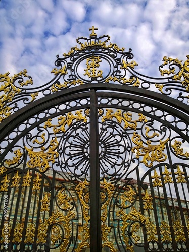 Gate of the Catherine Palace in Pushkin (Tsarskoye Selo), a suburb of St. Petersburg, Russia. A favorite place for excursions and travel of tourists. Metallic forged black and gold lace of fence.