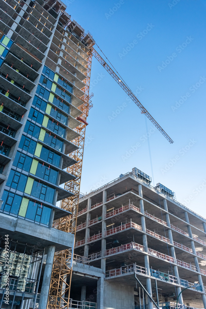 Fototapeta premium High-rise buildings under construction on blue sky background.