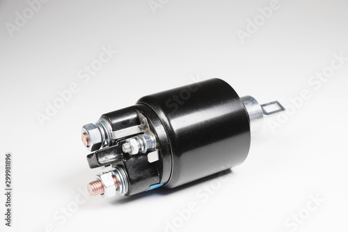 New black solenoid for a starter for a car on a gray gradient background. Auto parts. Starter Parts