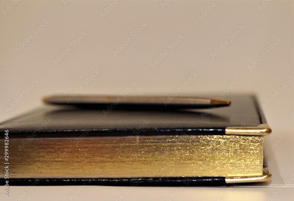 black book with gold pages on white background black book with gold pages on white background