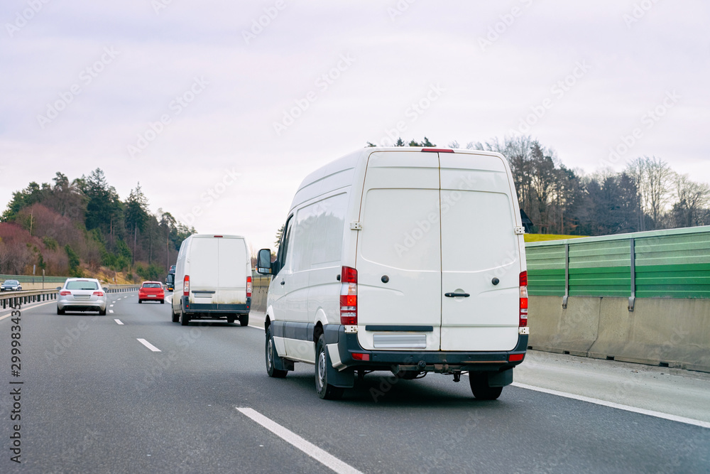 White Minivans in road