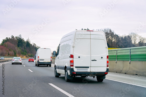 White Minivans in road