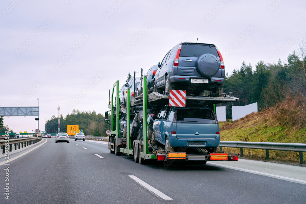 Cars carrier transporter truck in road