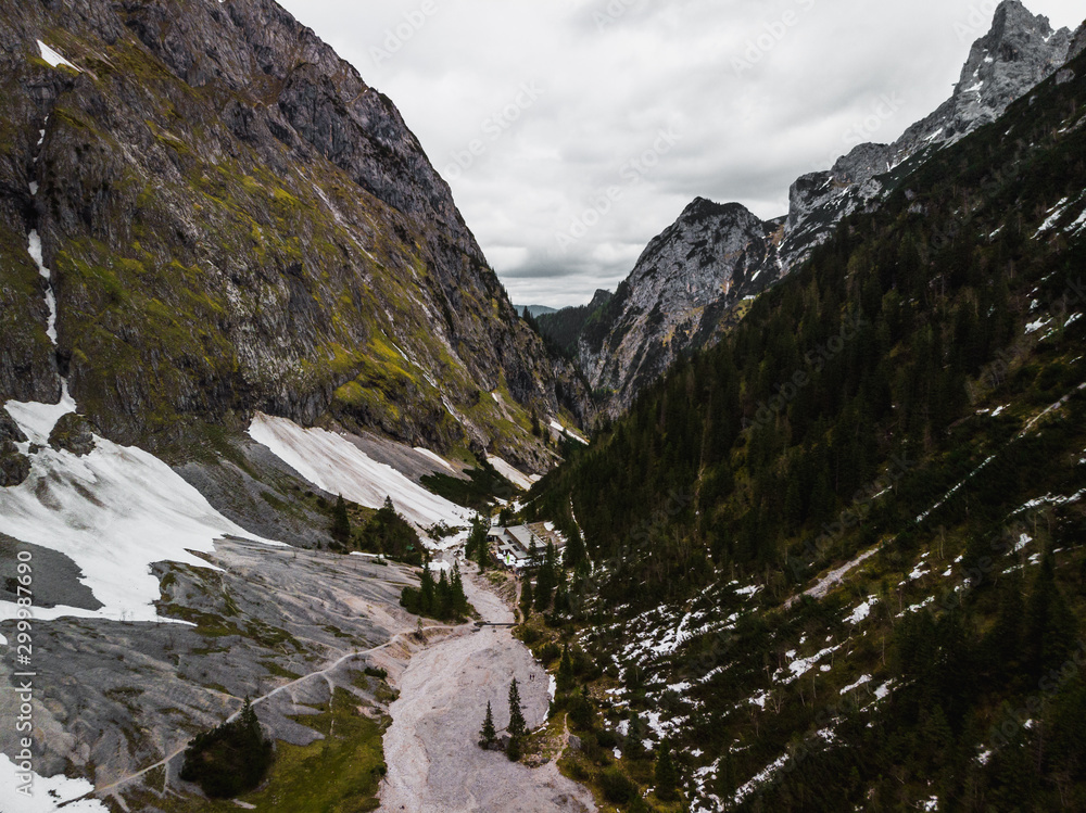 Moody aerial panorama from above the Höllentalanger during a hike in early summer in the Alps near the Zugspitze (Grainau, Germany, Europe)