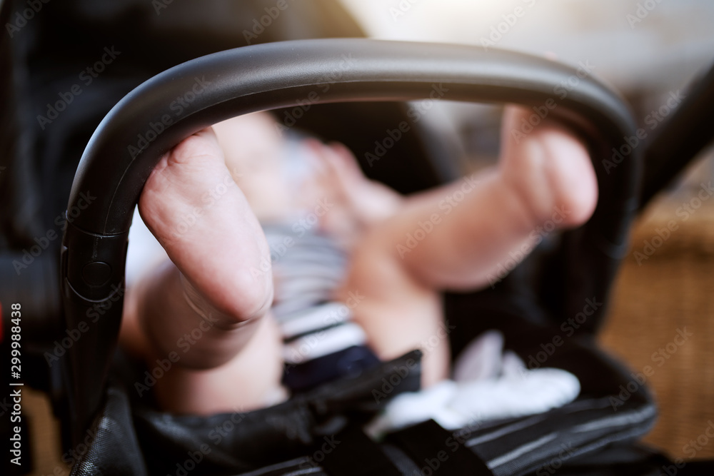 Close up of baby boy's feet. Baby sitting in stroller. Close up of baby boy's feet. Baby sitting in stroller.