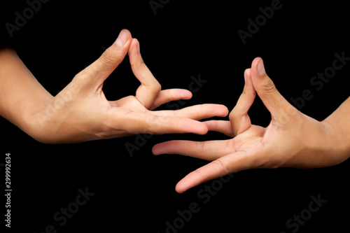 Isolated hands of male teenager doing or practicing Prithvi Yoga Mudra or Earth posture horizontal shot. Joining ring finger to thumb and forming Prithvi Mudra. photo