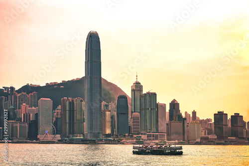Star ferry at Victoria Harbor and HK skyline at sunset