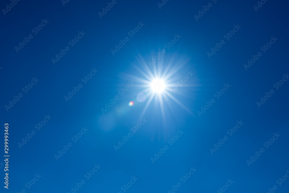 Sun, sunbeams against blue sky - cloudless heaven. Photography with Lense flair effect - obrazy, fototapety, plakaty 
