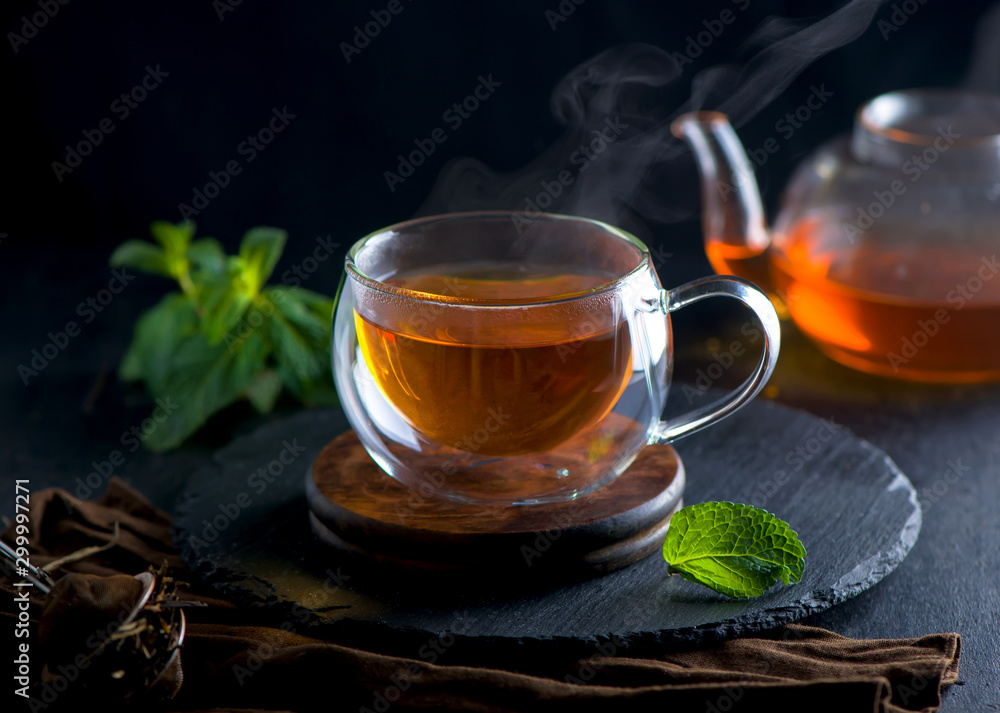 Tea concept, teapot with tea surrounded on wood background Tea concept, teapot with tea surrounded on wood background