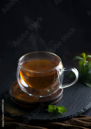 Tea concept, teapot with tea surrounded on wood background