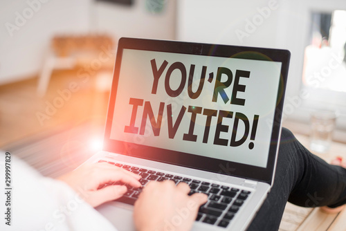 Text sign showing You Re Invited. Business photo text make a polite friendly request to someone go somewhere woman laptop computer office supplies technological devices inside home