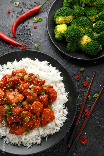 Tso's chicken with rice, green onion and broccoli photo