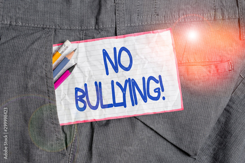 Text sign showing No Bullying. Business photo text stop aggressive behavior among children power imbalance Writing equipment and white note paper inside pocket of man work trousers