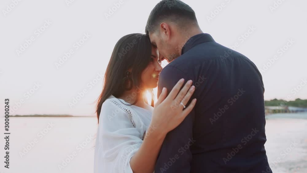Romantic date of beautiful man and woman on the shore of sea Romantic date of beautiful man and woman on the shore of sea