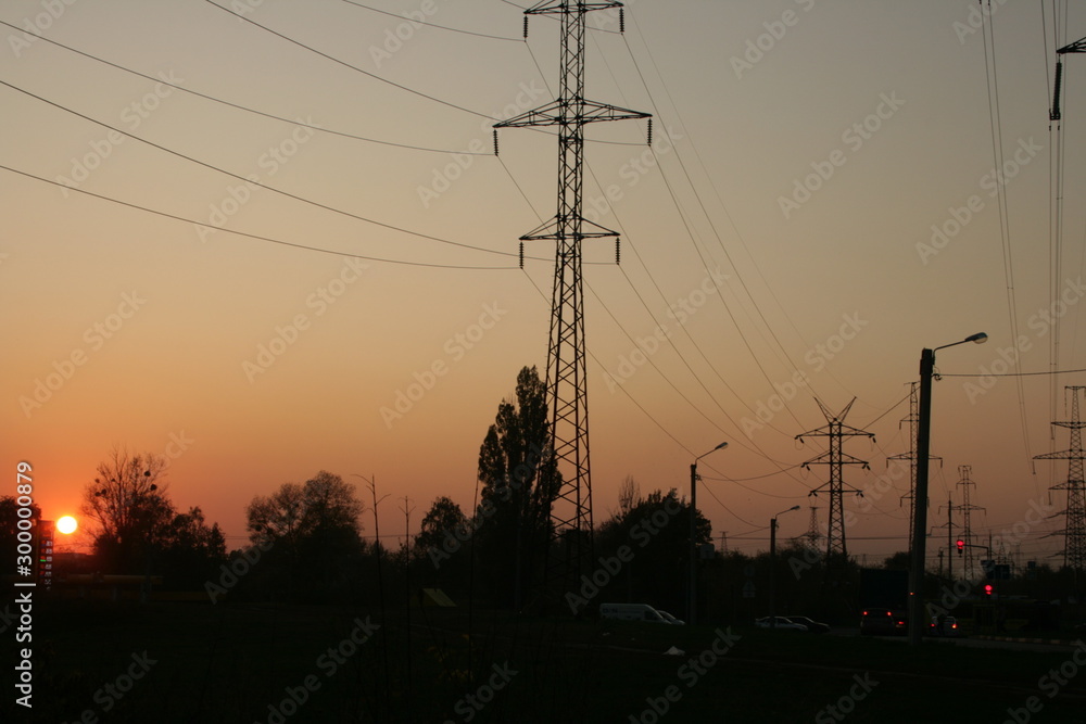 electric power lines and pylons at sunset