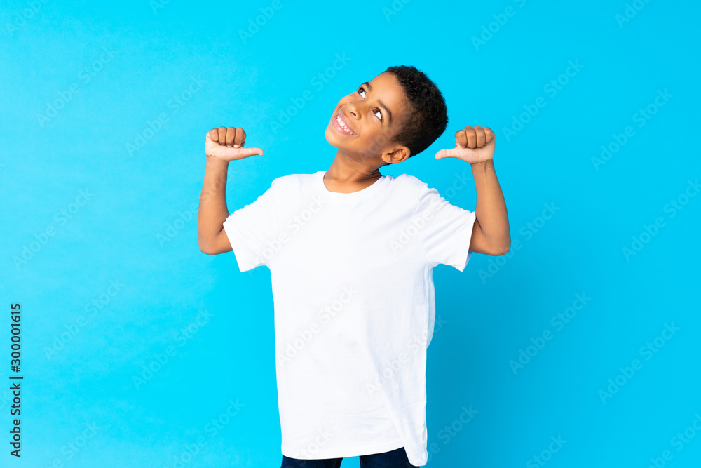 African American boy over isolated blue background proud and self-satisfied African American boy over isolated blue background proud and self-satisfied