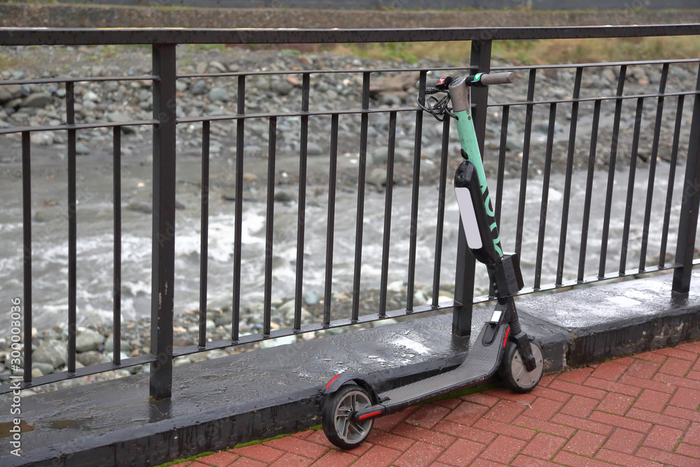 Modern miniature electric scooter for city walks and trips