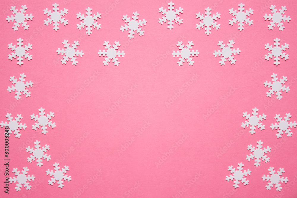 Winter backgound with snowflakes on pink backgound with copy blank space Winter backgound with snowflakes on pink backgound with copy blank space