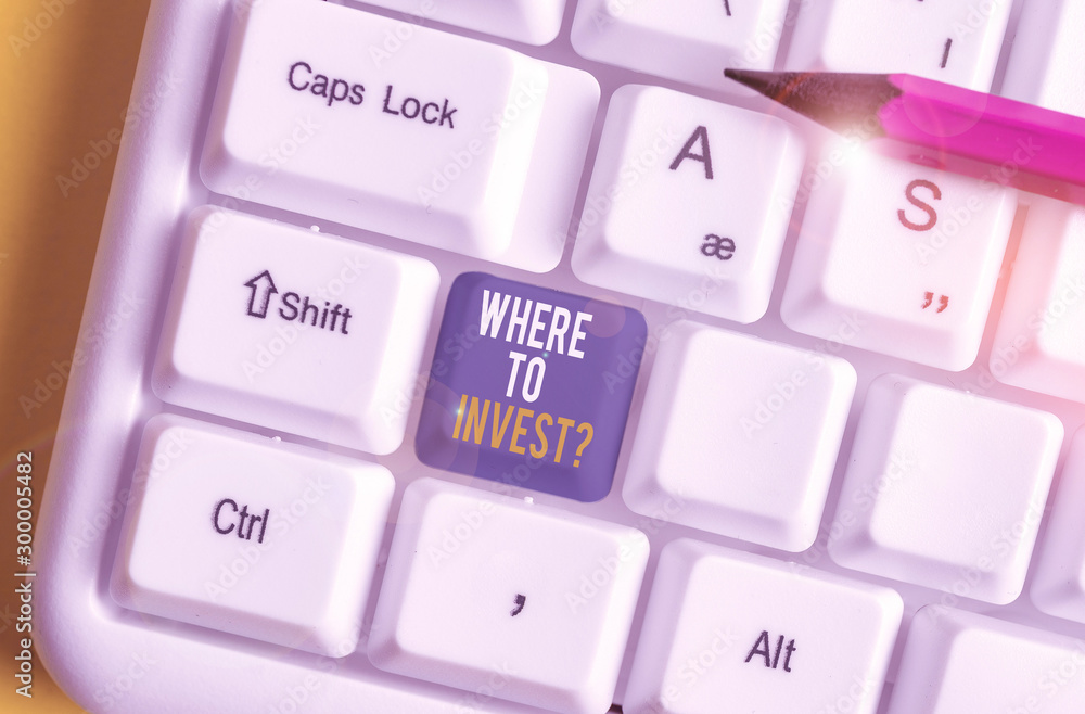 Handwriting text Where To Invest Question. Conceptual photo asking about where put money into financial schemes or shares White pc keyboard with empty note paper above white background key copy space Handwriting text Where To Invest Question. Conceptual photo asking about where put money into financial schemes or shares White pc keyboard with empty note paper above white background key copy space